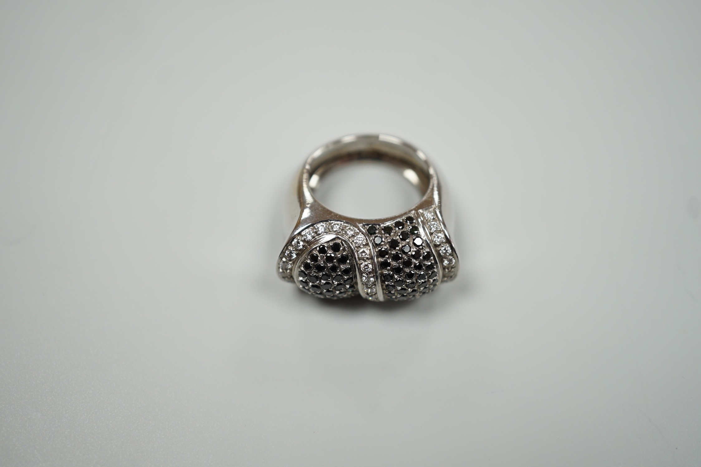 A modern 750 white metal and pave set two colour diamond dress ring, size K/L, gross weight 15.4 grams.